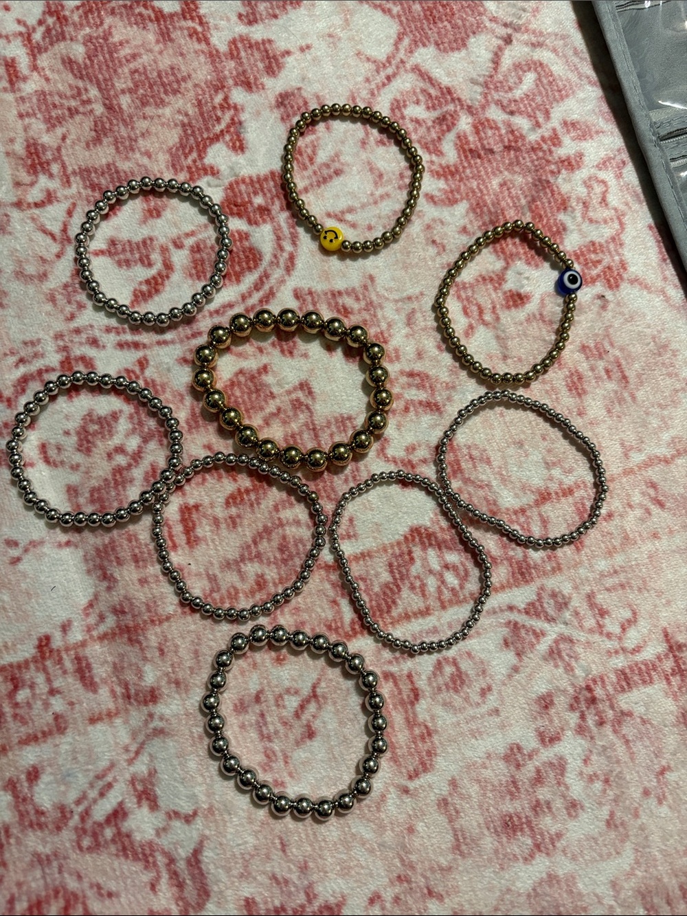 Beaded Stretch Bracelets with Smiley Charm and Evil Eye Set of Nine. Two tones